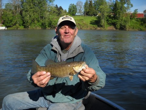 Angler holding a good-sized smallmouth bass caught in the Clackamas County section of the Willamette River.