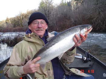 A fisherman holding a steelhead.