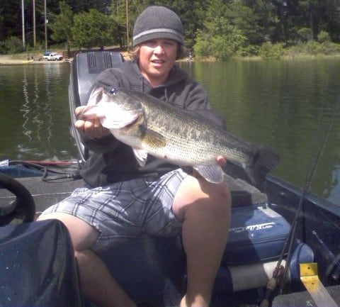 An angler holding a large bass.