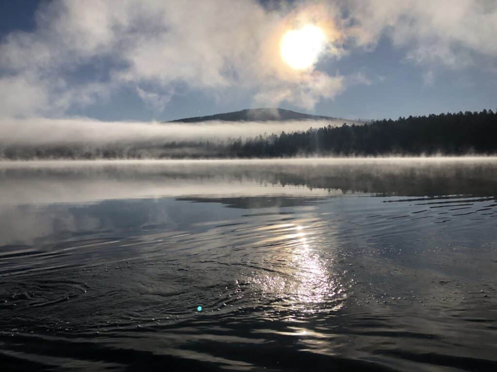 A scenic view of davis lake with mist.