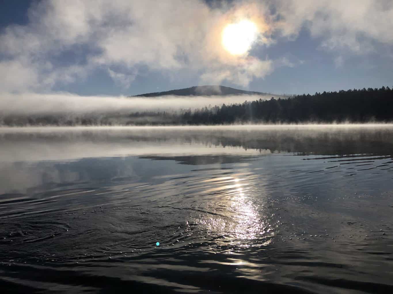 A scenic view of davis lake with mountains.