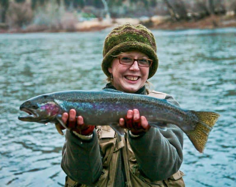 An angler holding a steelhead caught at grande ronde.