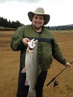 An angler holding a monster trout caught at henry hagg lake.