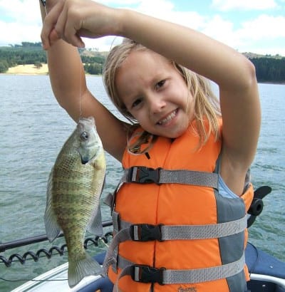 A girl holding a crappie she caught at one of the lakes near Portland.