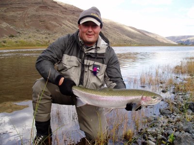 An angler holding a steelhead caught at john day river.