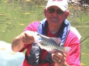 An angler holding a fish.