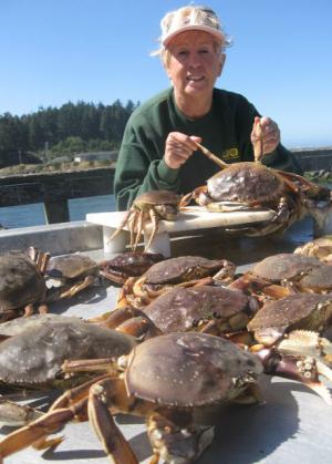 An angler holding a crab in Umpqua River Basin.