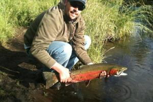 An angler holding a fish.