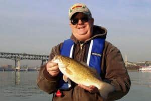 A fisherman holding a fish.