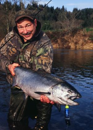 A fisherman holding a large fish.