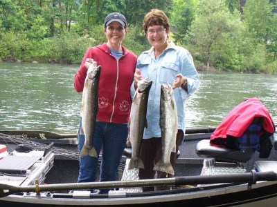 Anglers holding a bunch of steelhead.