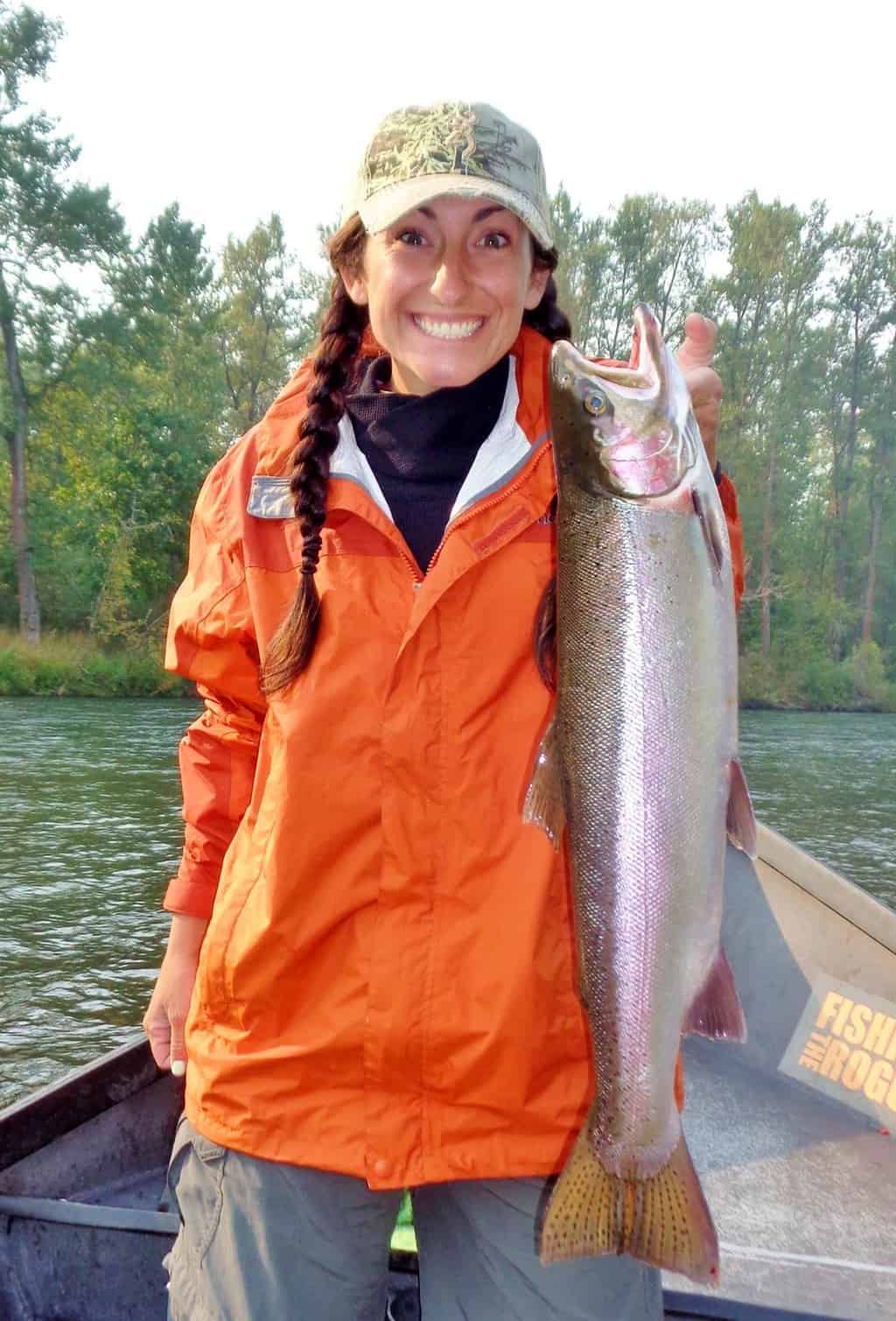 An angler holding a steelhead.