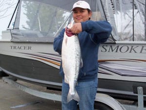An angler holding a very large kokanee salmon caught at wallowa lake.