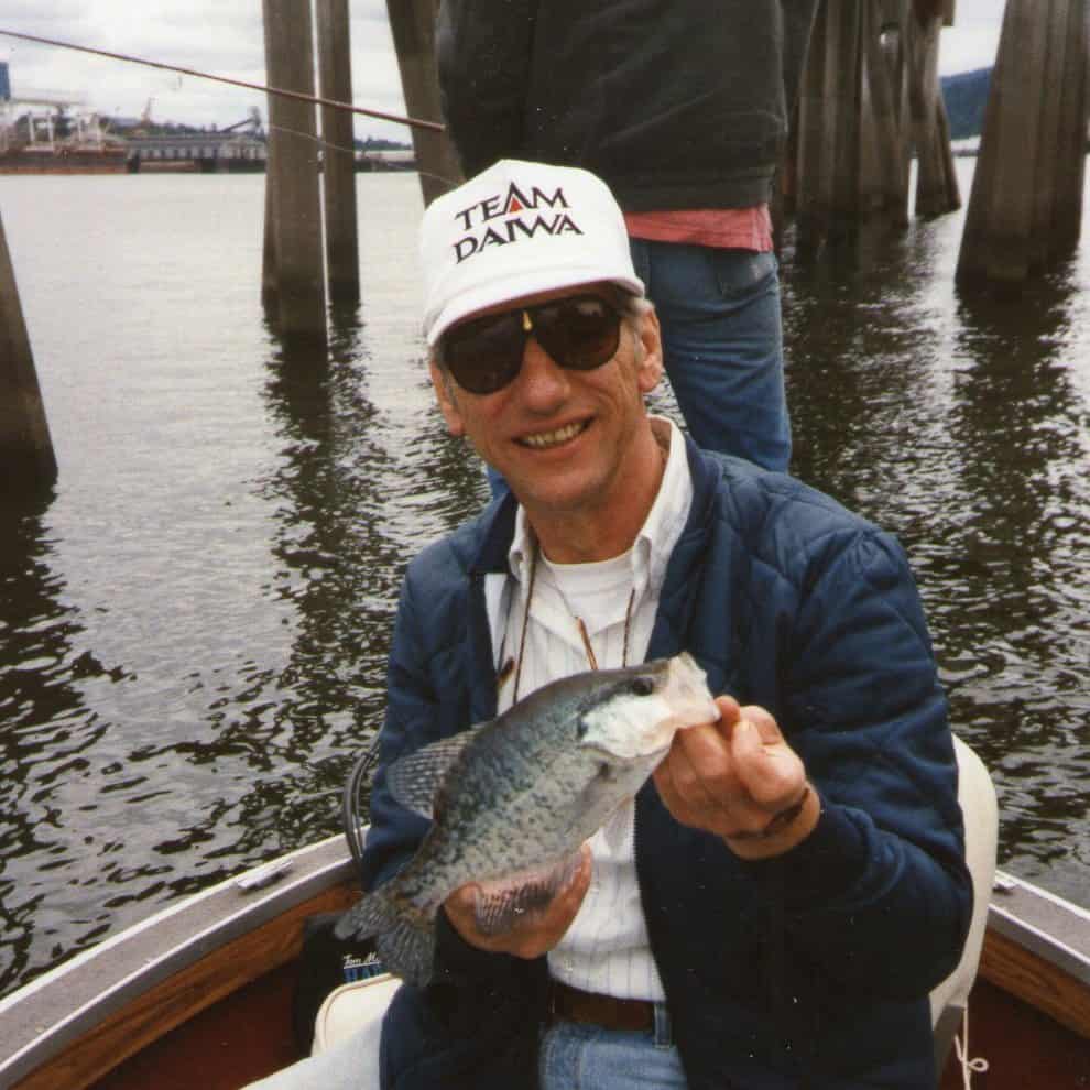 An angler holding a nice crappie caught fishing in the willamette river.