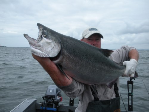 An fisherman holding a fish.