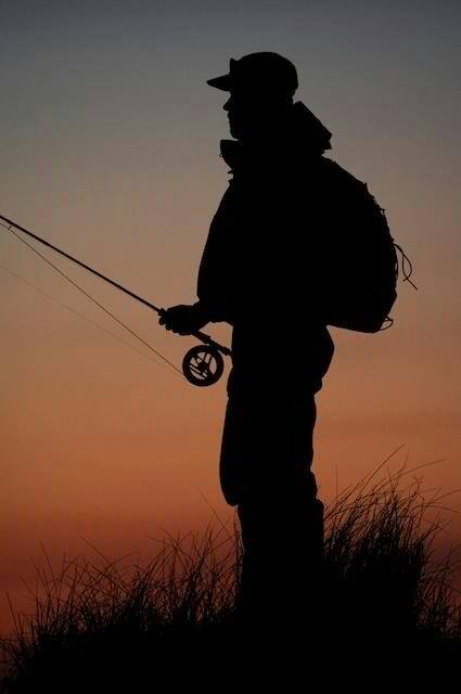 A silhouette of an angler fly fishing at grande ronde river.