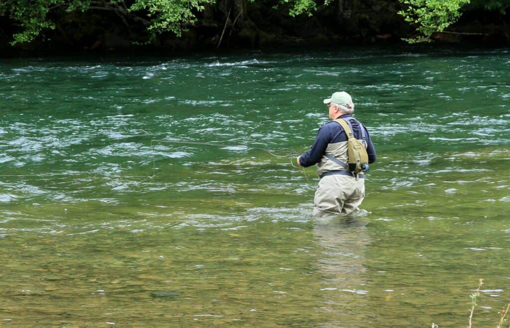 An angler fly fishing on the North Umpqua River.