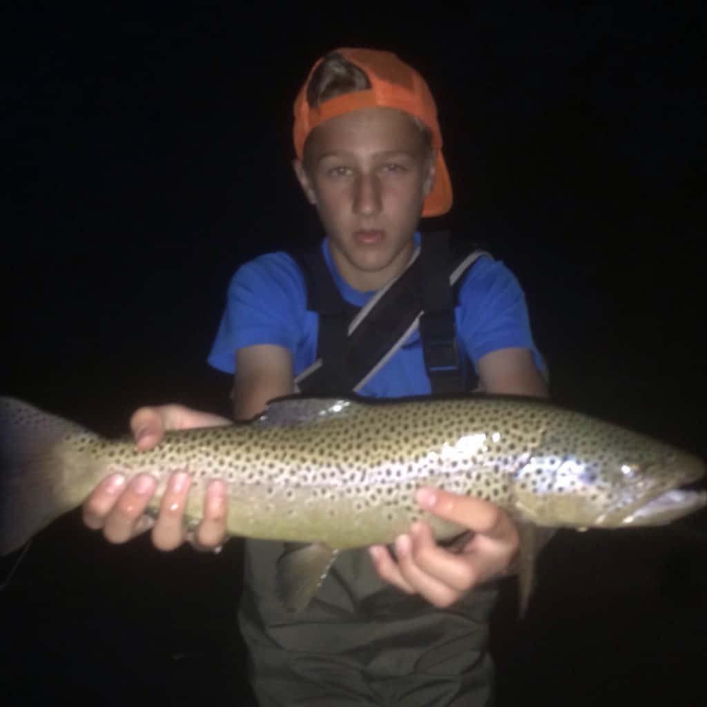 An angler holding a large brown trout caught in eastern oregon.