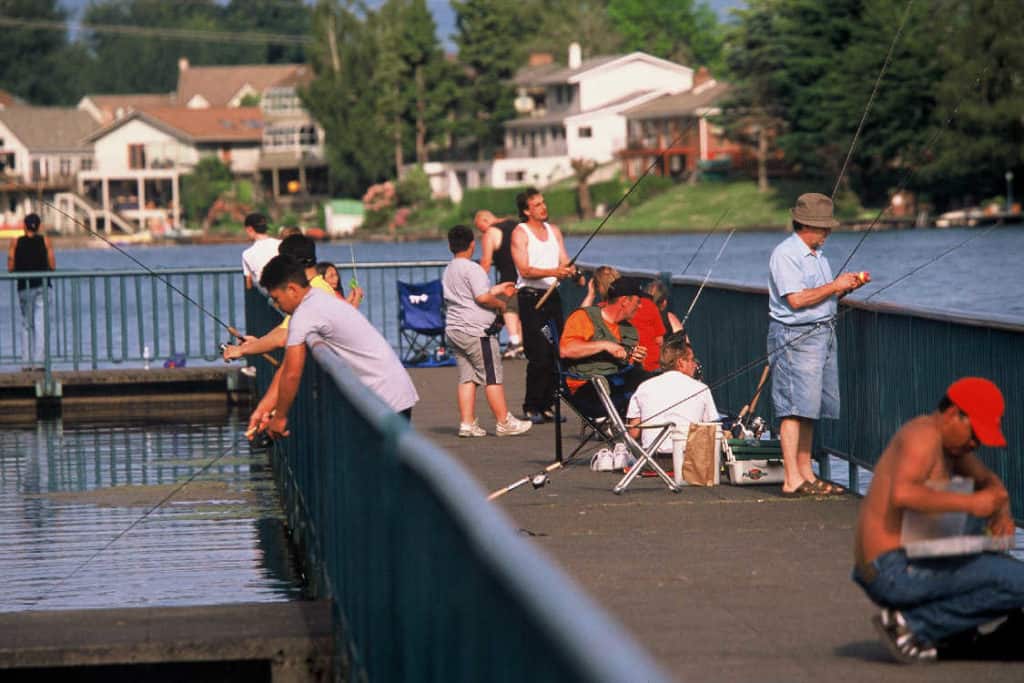 Lots of people fishing from a pier at blue lake regional park.