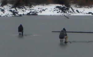 Anglers ice fishing on frozen Fish Lake.