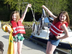 Kids hold up a stringer of trout caught at detroit lake.