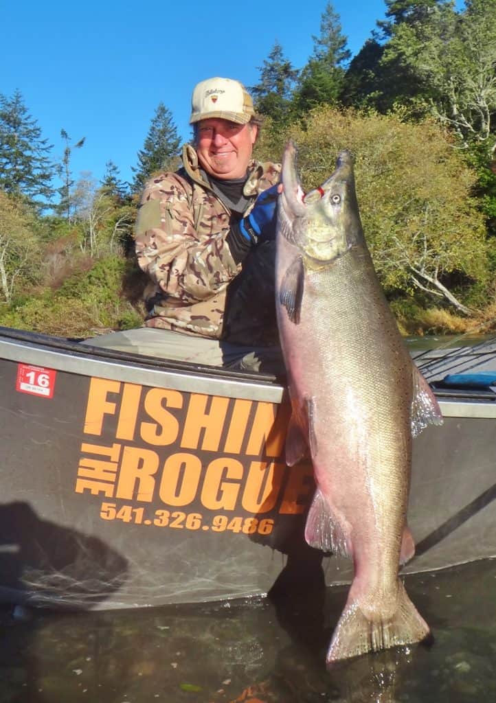 An angler holding a salmon caught at elk river.