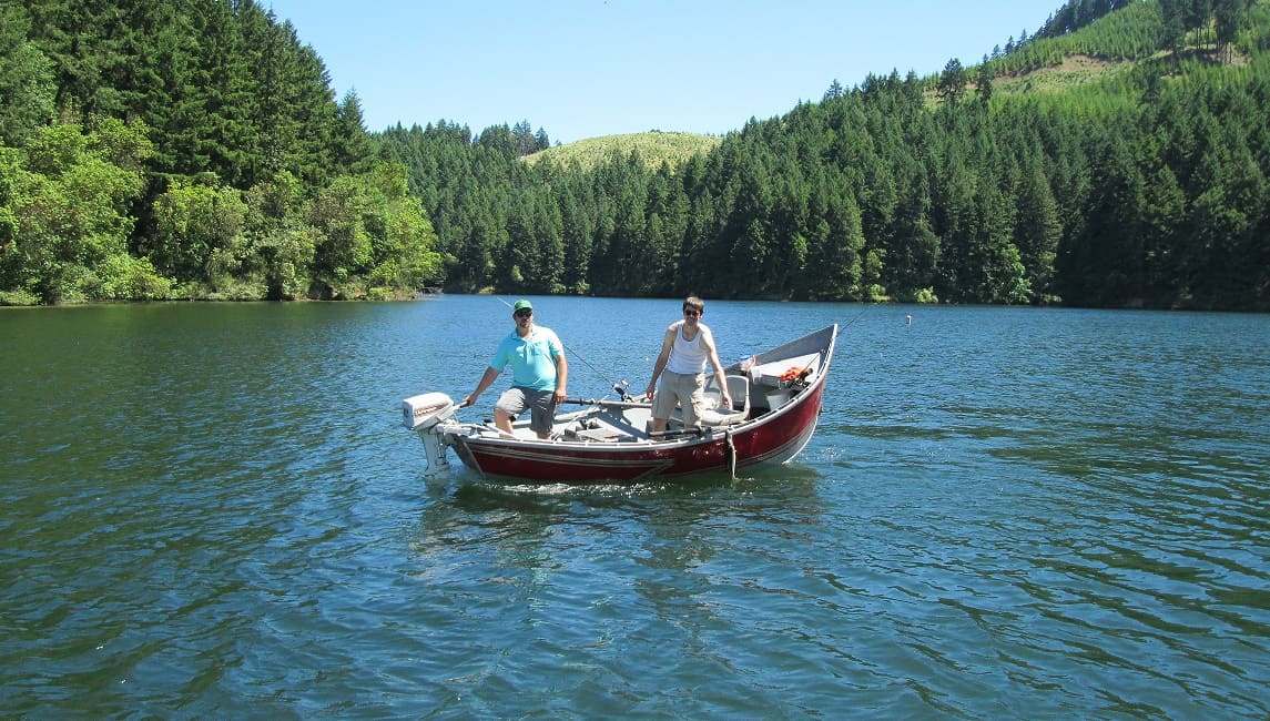 Two people fishing in a boat at Cooper Creek Reservoir in Southwestern Oregon.