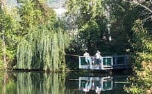 A scenic view of reinhart pond with two anglers in the background.