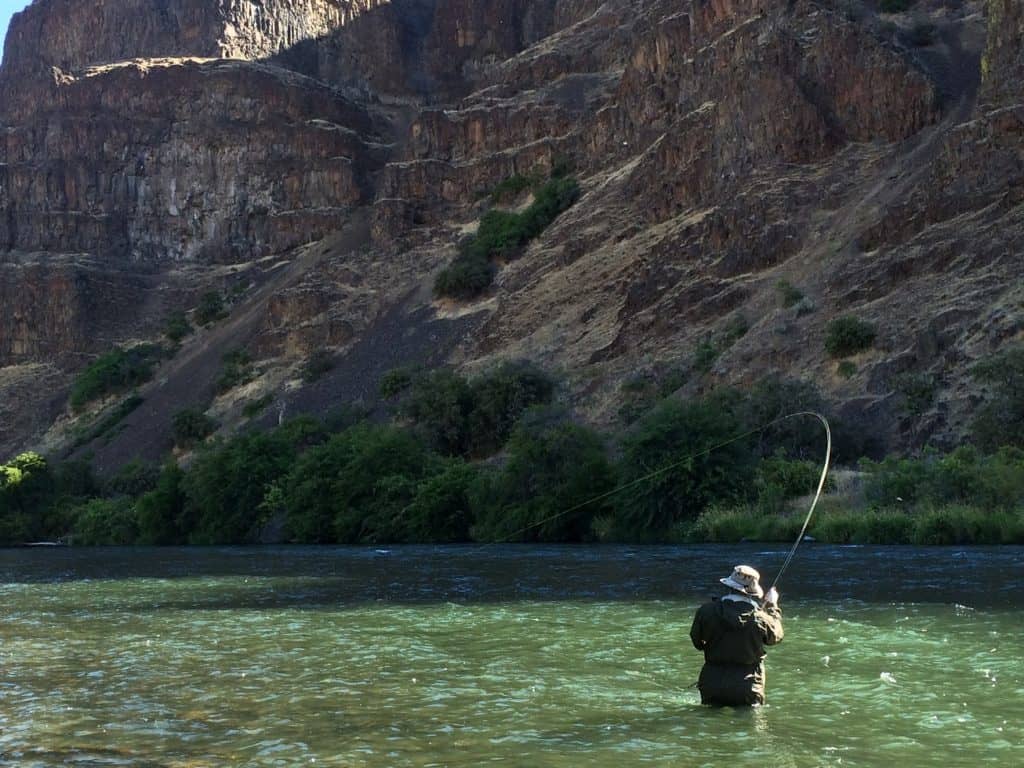 An angler fly fishing at Deschutes River.