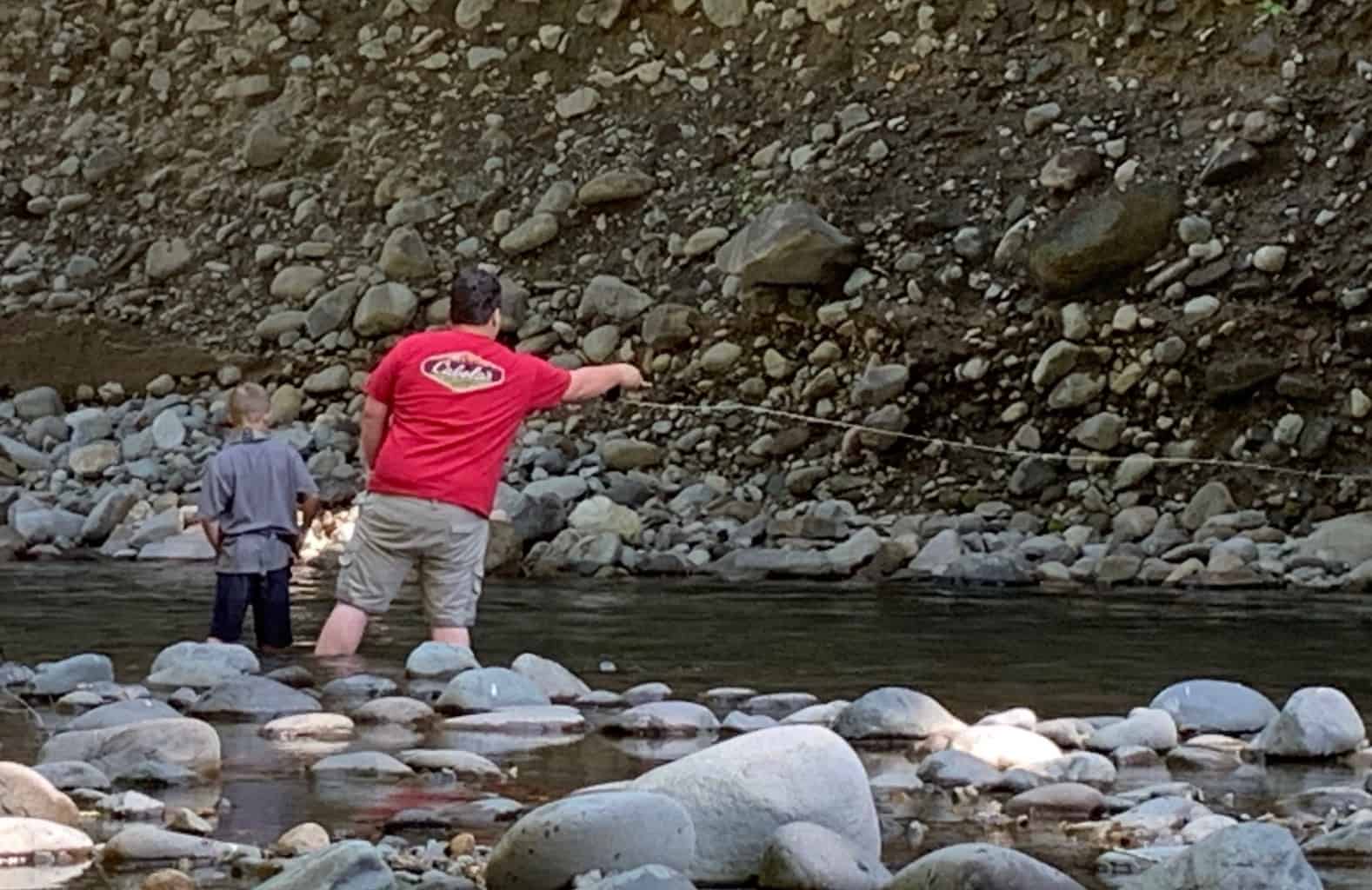 An angler fly fishing at breitenbush river.