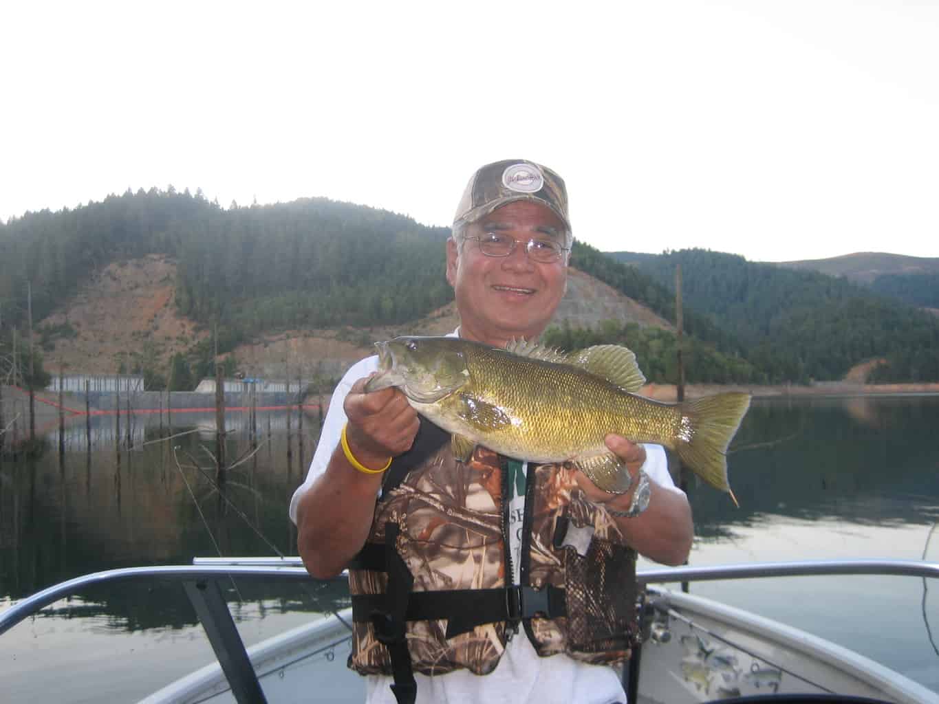 A angler holding a largemouth bass caught at galesville reservoir.