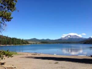 A scenic view of elk lake with a mountain in the background.