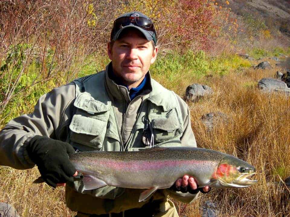 An angler holding a steelhead caught at grande ronde river.