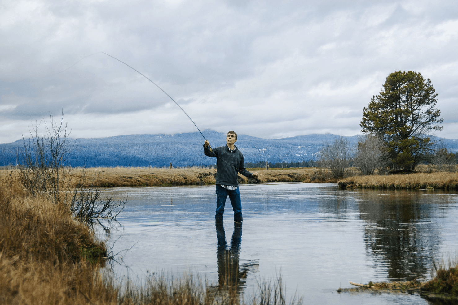 An angler fly fishing for trout in wood river.