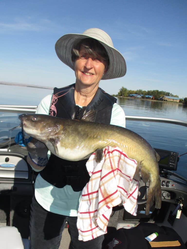 A woman holding a columbia river channel catfish.