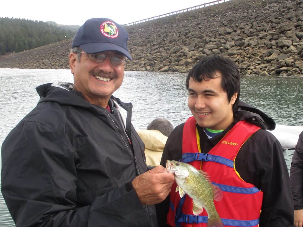 Man and boy with a smallmouth bass at Hagg Lake in Oregon.