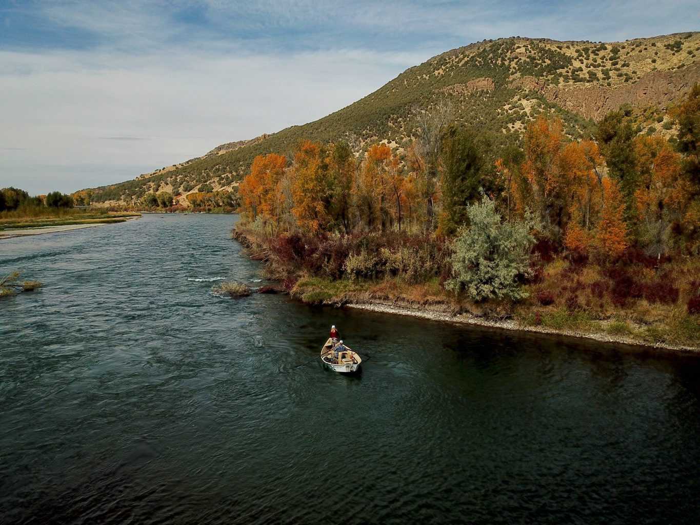 Fly fishermen use drift boats and rafts to reach more fish on the henry's fork of the snake river.