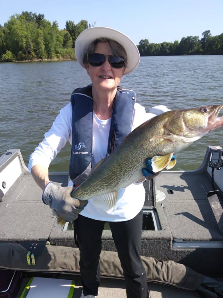 An angler holding a walleye caught in the multnomah channel.