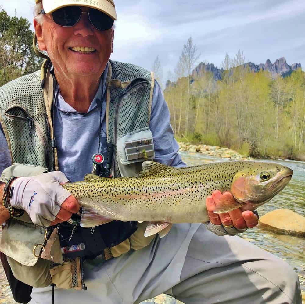 Upper sacramento fly fisherman holds a big trout.