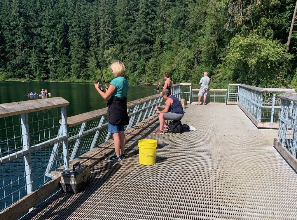 Anglers fishing from the dock at battle ground lake in washington.