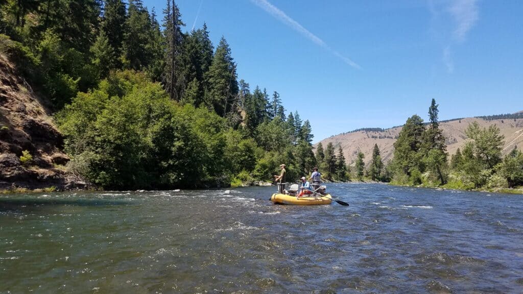 Fly anglers fishing from a raft on the Naches River in central Washington.