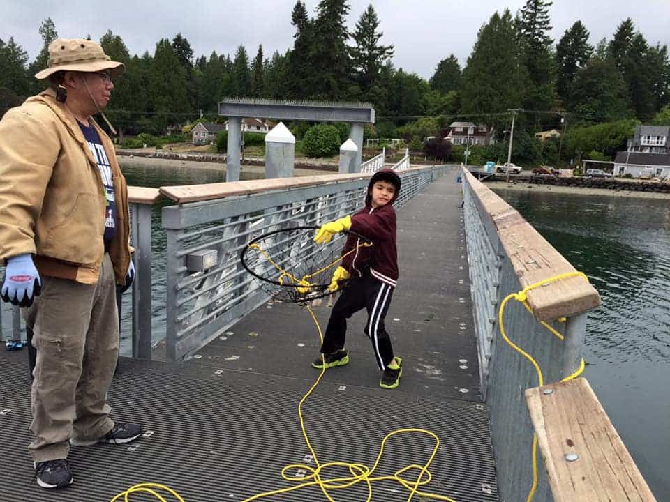 Boy crabbing from Harper Pier in Kitsap County, Washington