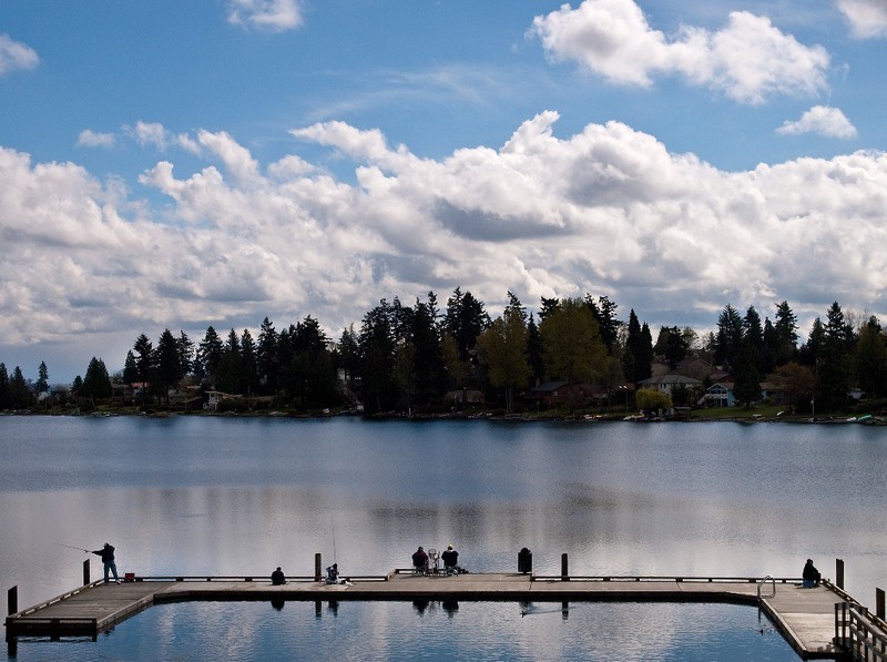 People fish from the pier at Angle Lake in SeaTac, Washington.