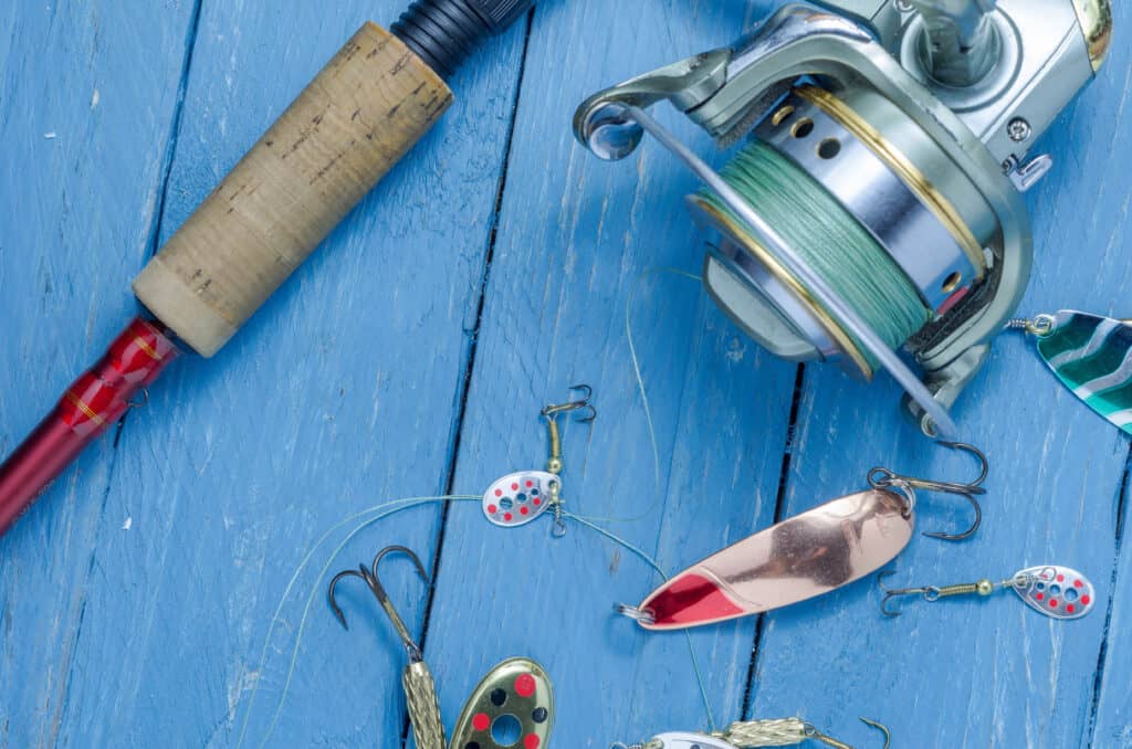 Fishing lures with a spinning reel and rod.