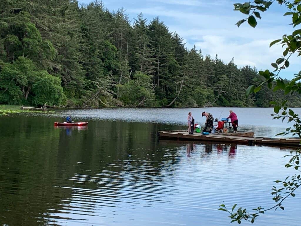 Dock anglers and a kayaker share a cove at the north end of Coffenbury Lake.