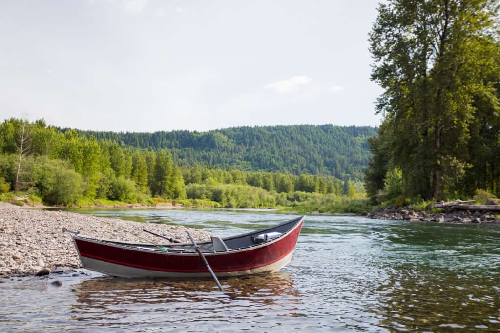 Drift boat sits along the banks of the McKenzie River.