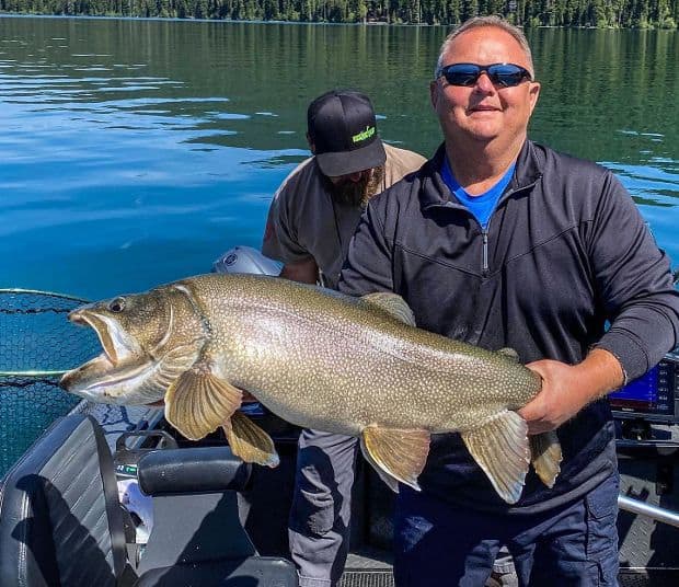 Angler holding a trophy lake trout caught at Odell Lake in central Oregon.