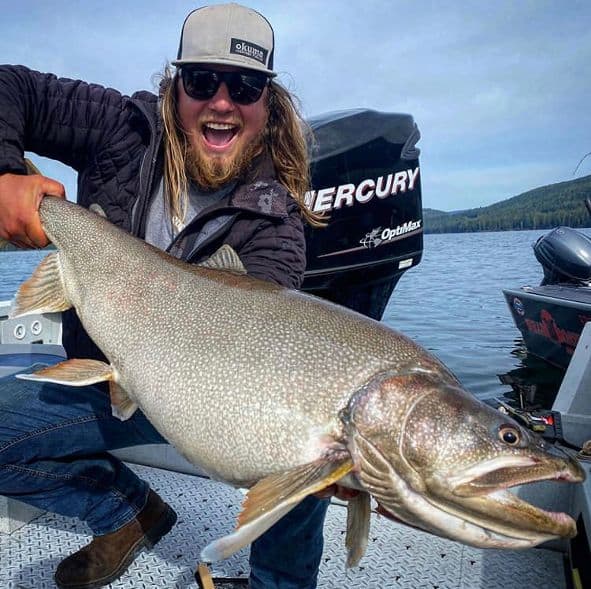 A fisherman with a giant sized odell lake mackinaw trout.