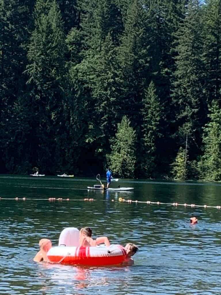 Anglers kayaking while other anglers share the lake with swimmers and other water lovers.