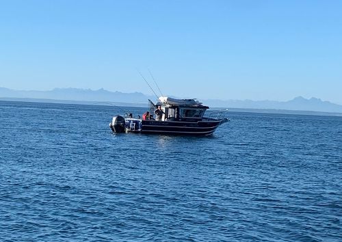 A boat fishing off the san juan islands.